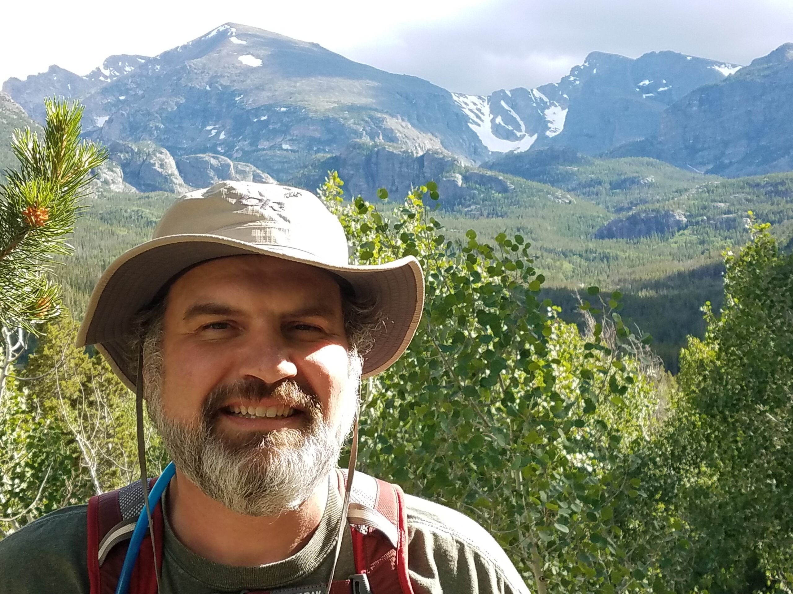 Photo of Aaron Ahlquist with a mountain range behind him