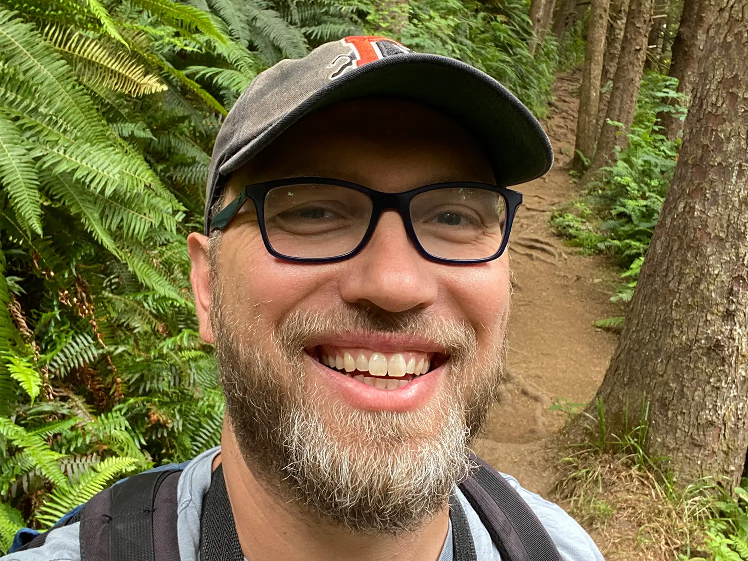 Photo of Daniel Ahlquist on a forest path