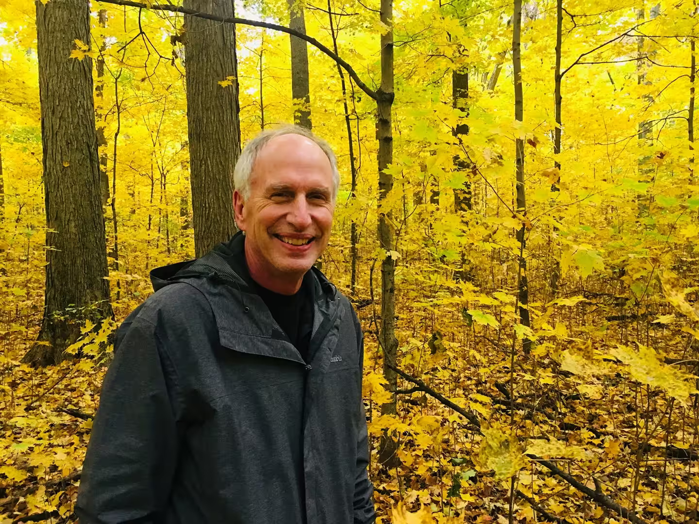 Photo of David Ahlquist taken in the woods during the Fall